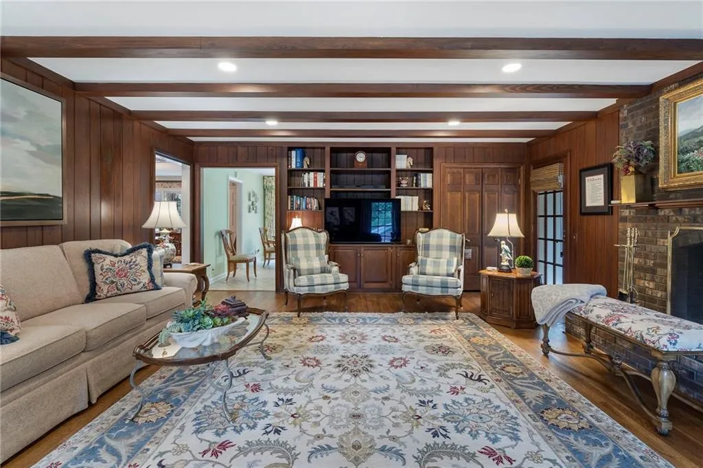 Gorgeous paneling and built-in shelving makes this room perfect for cozy family get together.