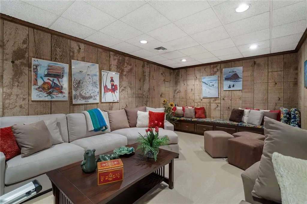 This home has a large terrace level with a bar area and a large room that is not pictured currently being used as storage