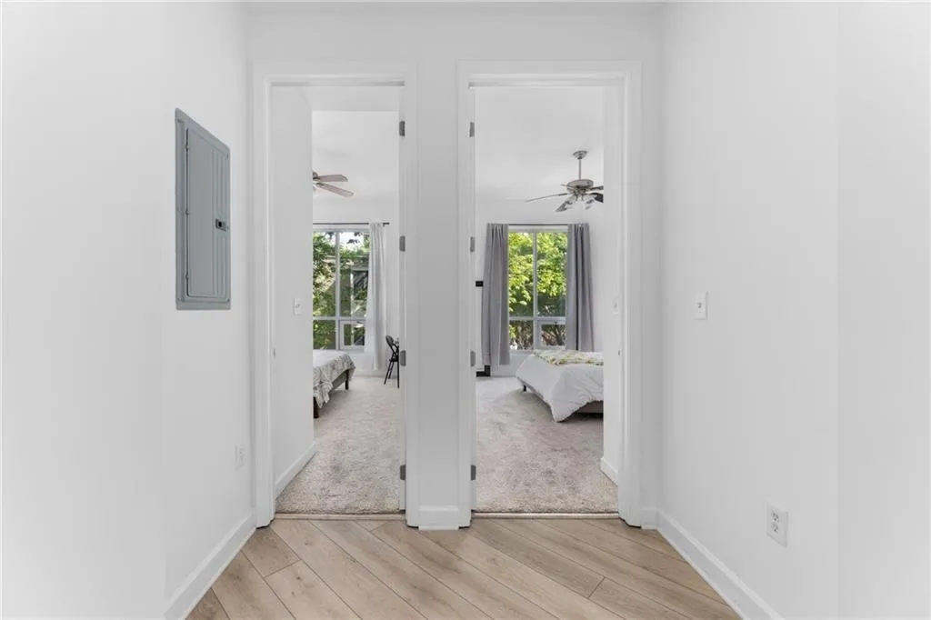 Hallway featuring light wood-style flooring and electric panel