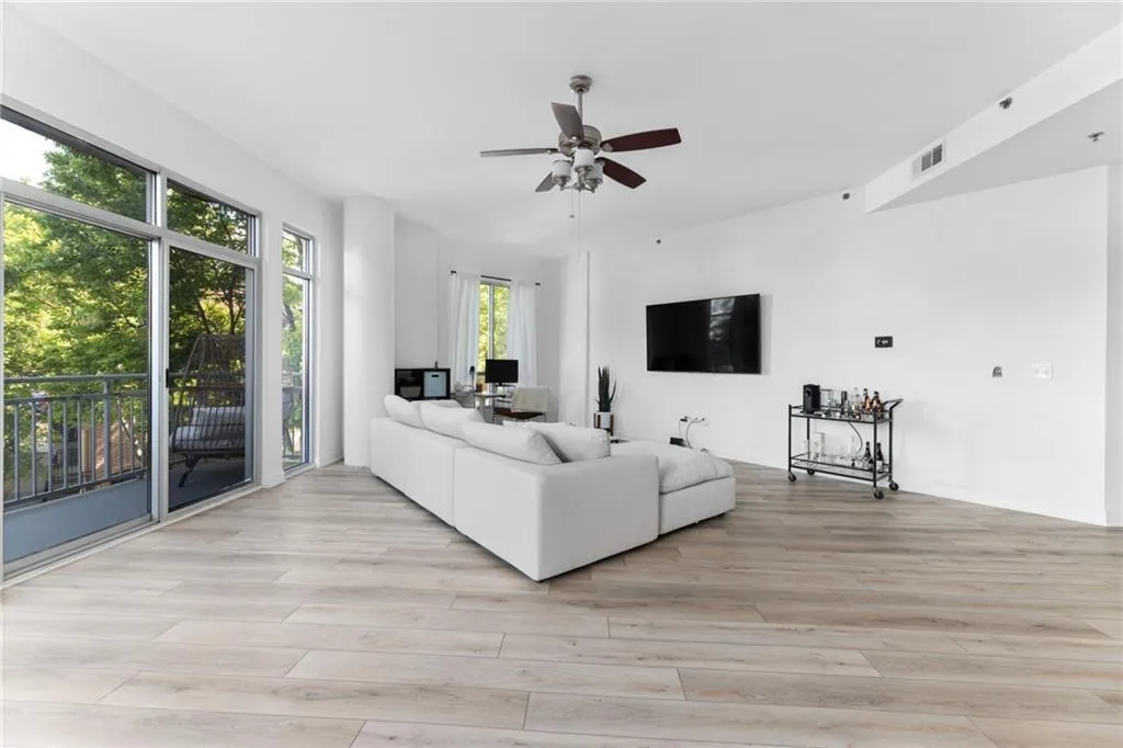 Living room featuring light wood finished floors and ceiling fan
