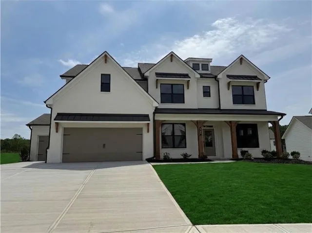 Modern two-story residence with white brick exterior and dark framed windows