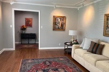 Living area with dark wood finished floors and rail lighting