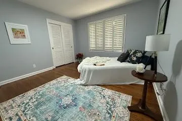 Bedroom featuring oak flooring