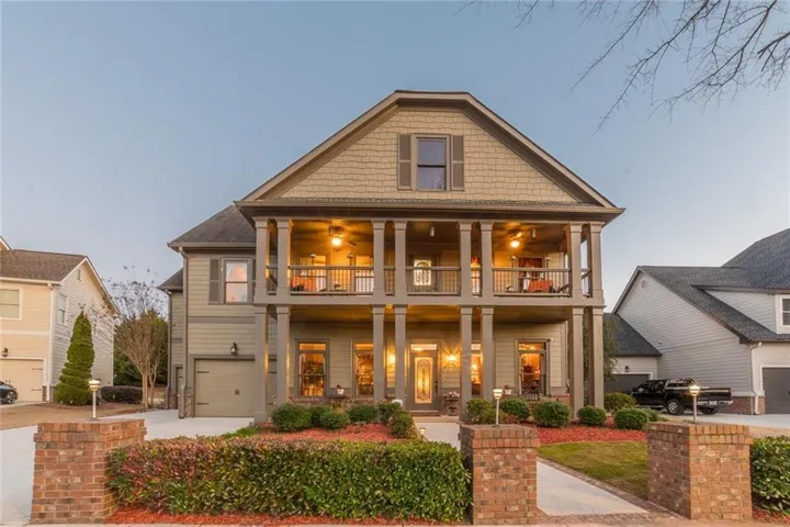 Two-story home with a prominent gabled roofline and shake siding accents