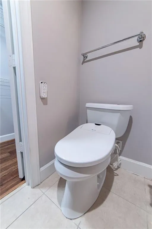Bathroom with toilet and tile patterned flooring