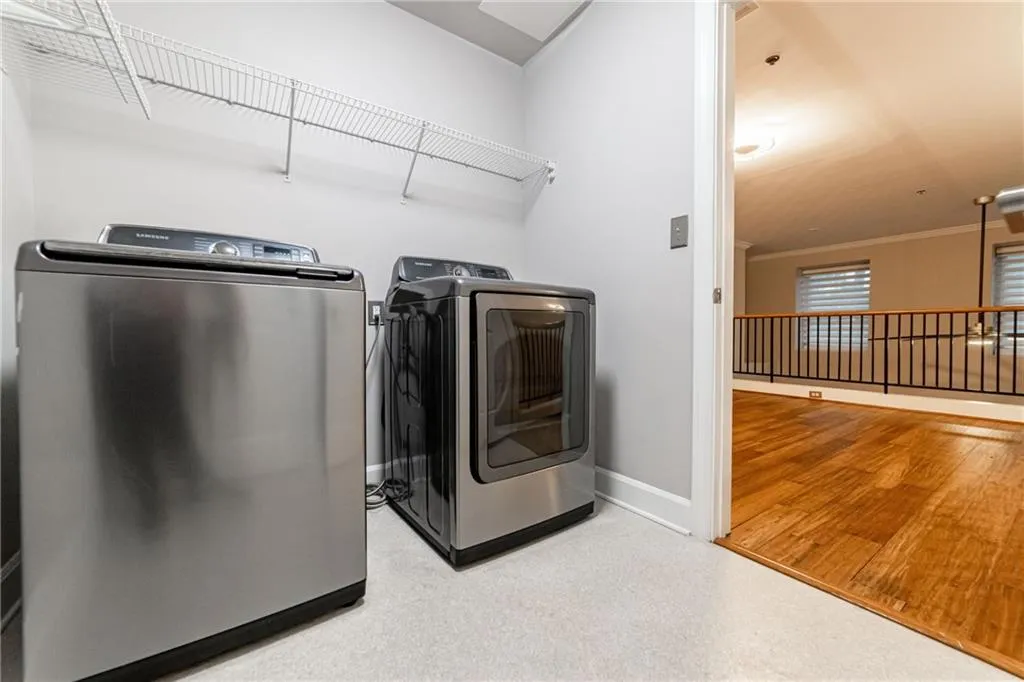 Washroom featuring washer and dryer and baseboards