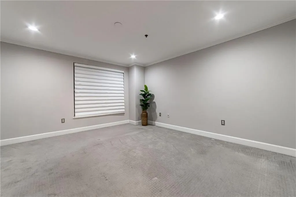 Spare room featuring carpet flooring, recessed lighting, and crown molding