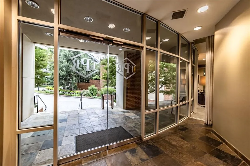 Doorway to outside with stone tile floors and recessed lighting