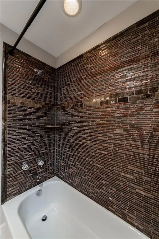 Bathroom featuring shower / washtub combination