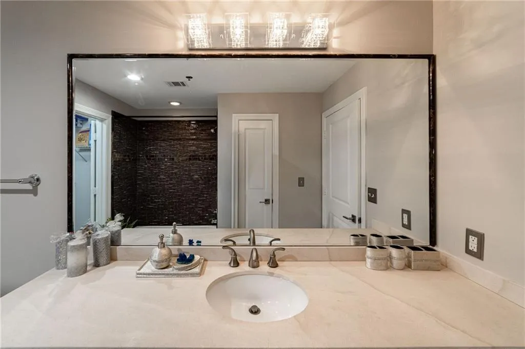 Bathroom featuring vanity and a shower