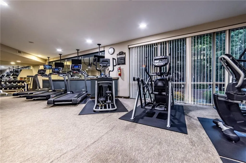Gym featuring carpet flooring and recessed lighting