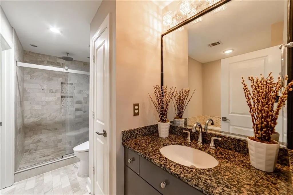 Bathroom featuring vanity and a shower stall