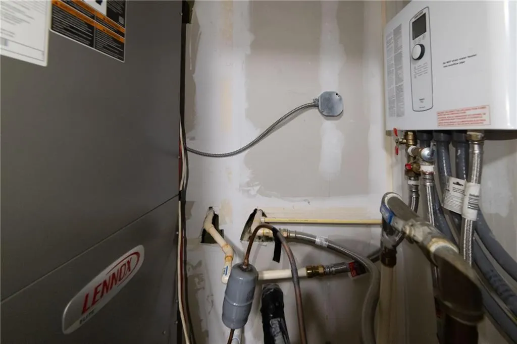 Utility room featuring water heater