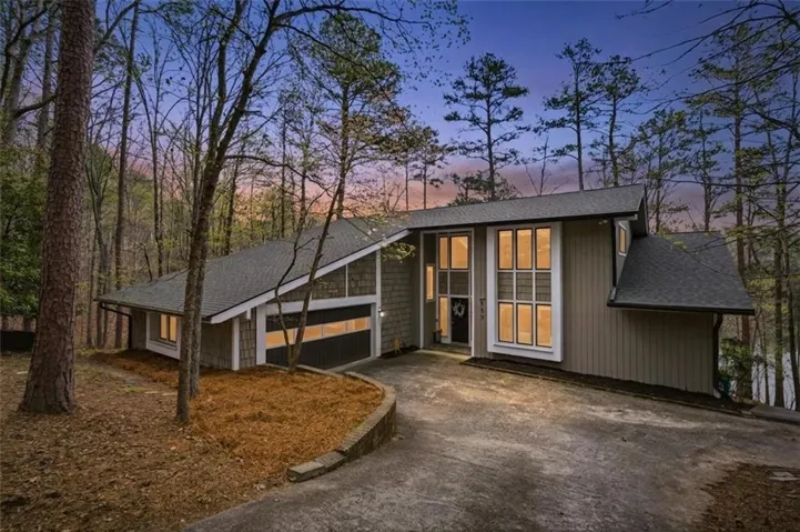 Contemporary architectural design featuring a prominent peaked roofline and extensive window placement