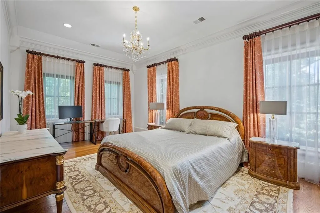 Every bedroom in this home is a retreat of its own - generous proportions, crystal chandelier, hardwood floor.