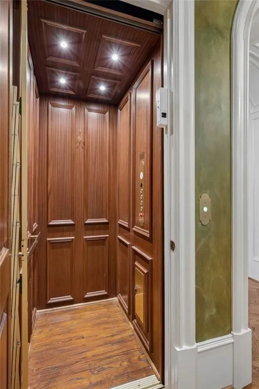 Even the elevator is a statement - custom wood-paneled walls, coffered ceiling, and hardwood floors. Because luxury truly lives on every level.