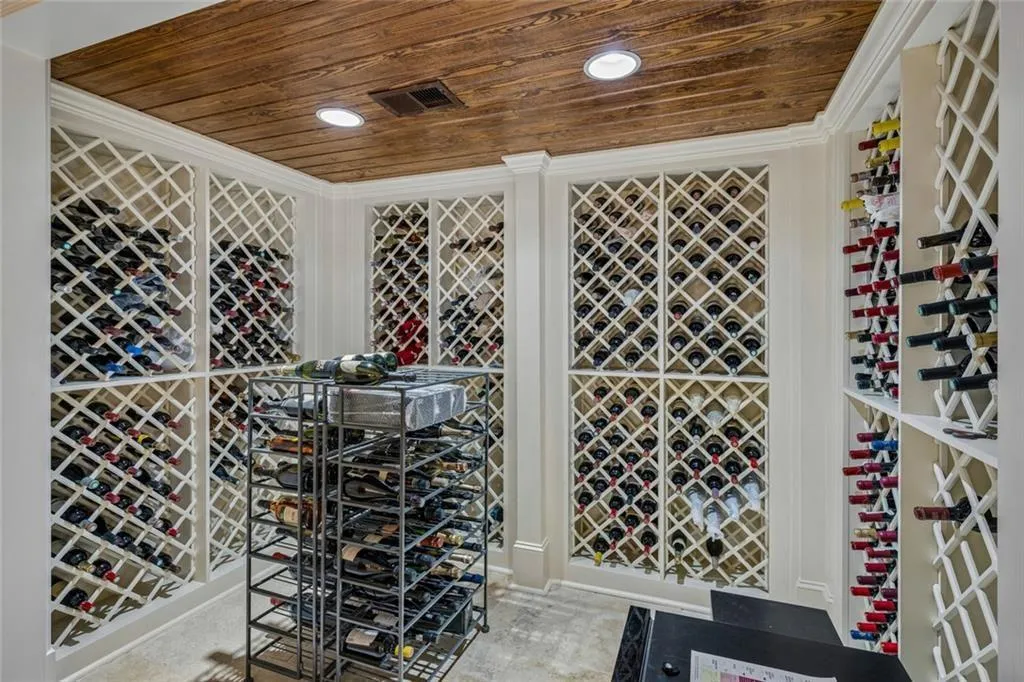 A wine connoisseur’s dream — a dedicated wine cellar with floor-to-ceiling custom racks, wood ceiling, and enough room for your most prized collection.