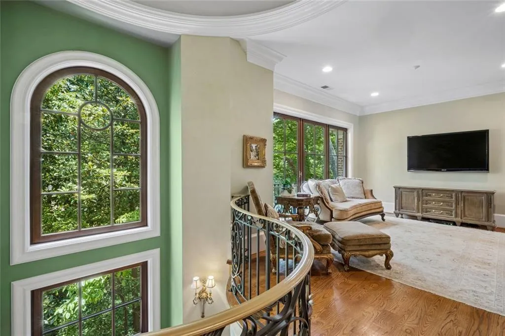 The upper level landing opens to a gracious sitting room.