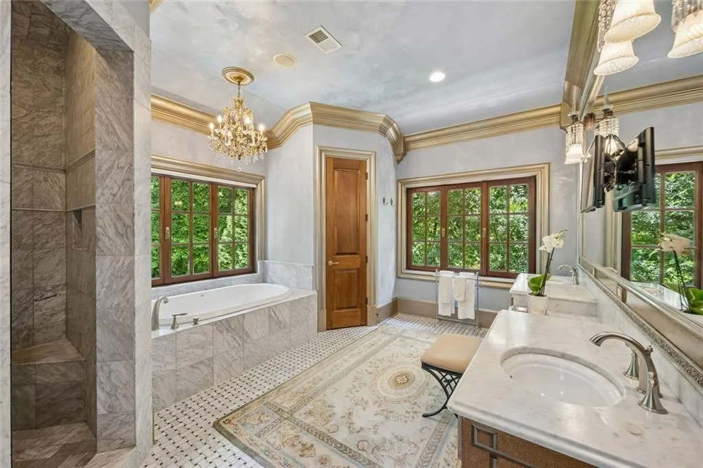 The primary bath is a spa experience every single day - stunning marble finishes.