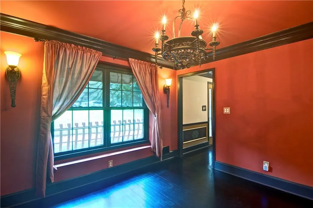 Dining room with large window, crown molding and beautiful lighting