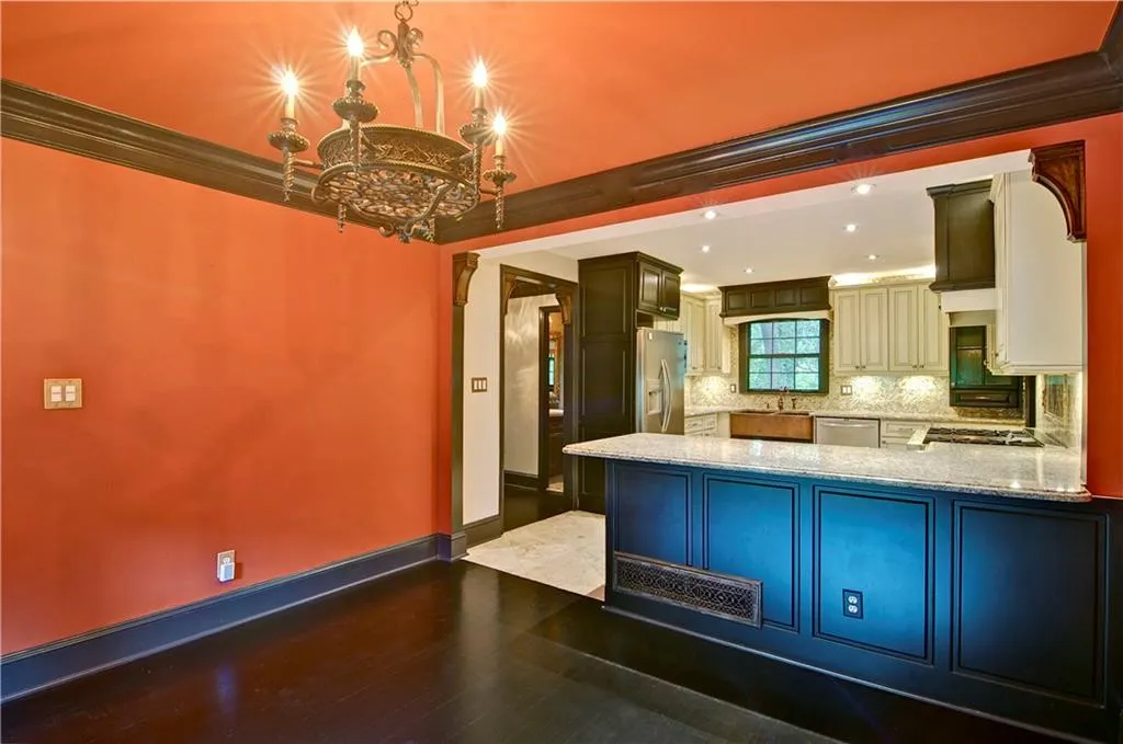 Another view of the dining room with hardwood flooring, crown molding and beautiful lighting