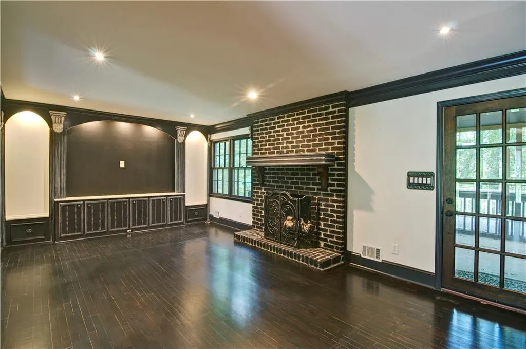 Family room featuring crown molding, a beautiful brick fireplace, hardwood floors, and recessed lighting