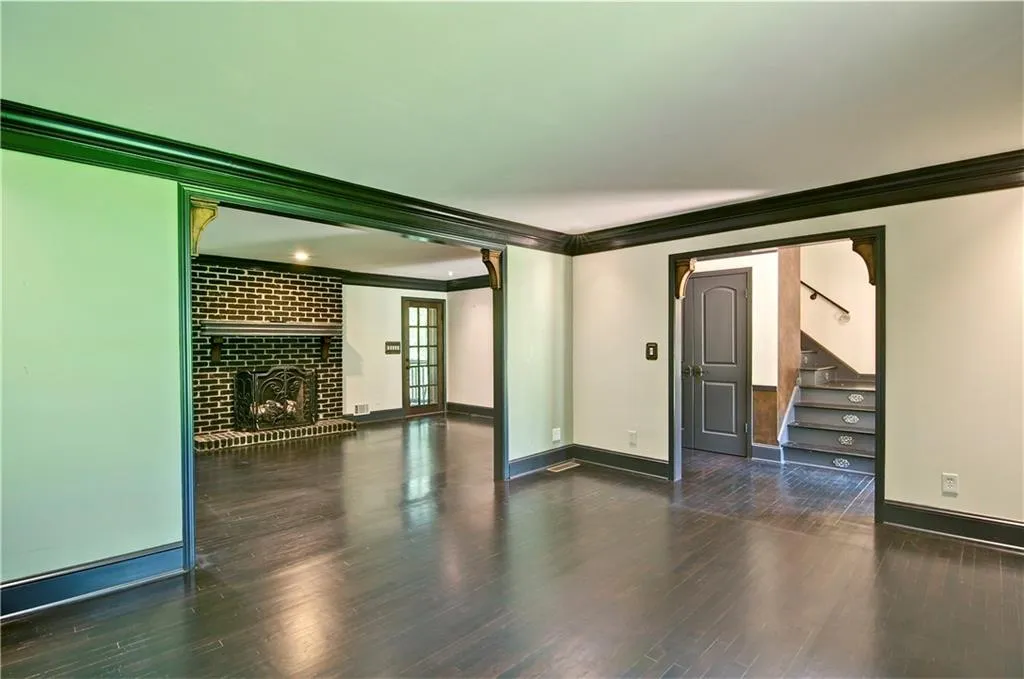 Living room featuring crown molding and hardwood floors