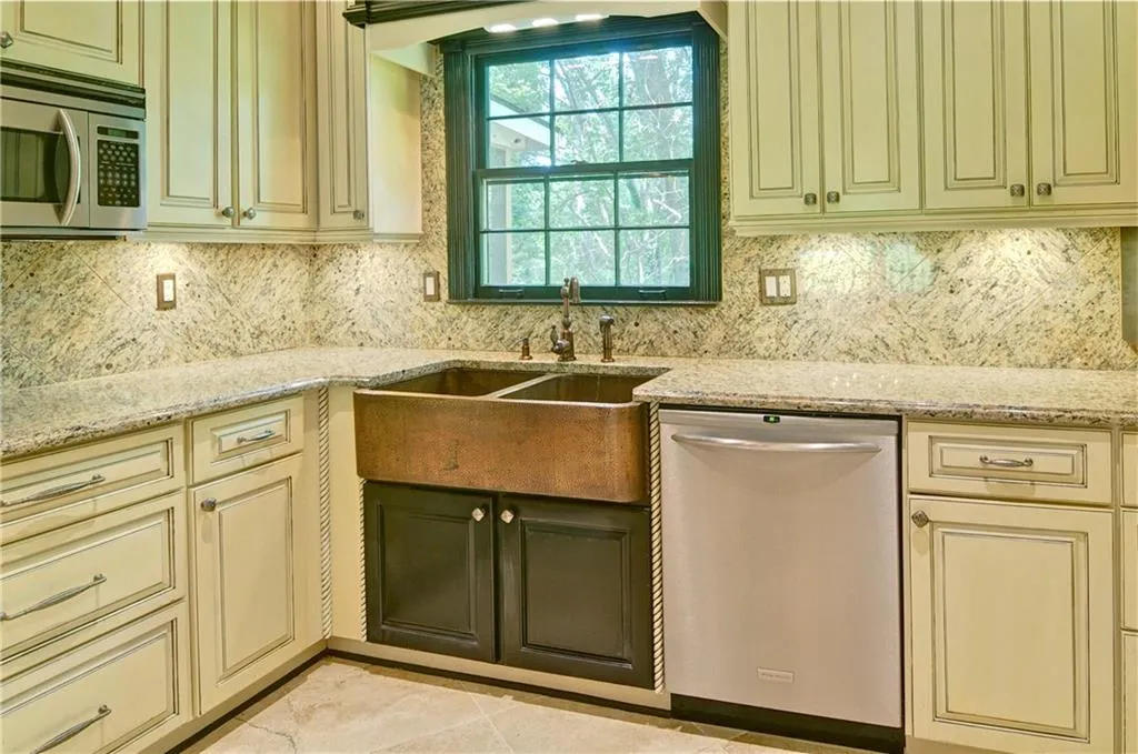 Beautiful farm style kitchen sink with large window to enjoy the outdoors.  Who wants to stare at a wall while doing dishes?