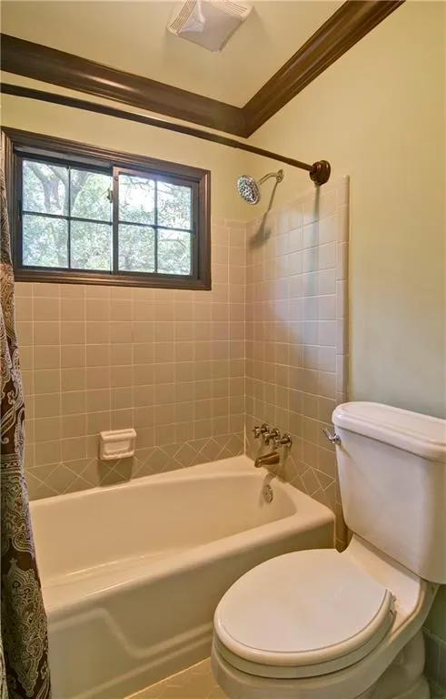 Upstairs hall bath also features crown molding and a tub/shower combo