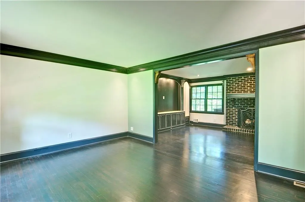 Living room with crown molding and hardwood floors