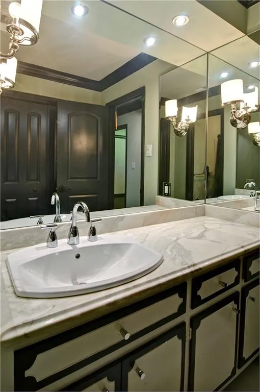 Upstairs hall bathroom featuring a vanity with stone counter top, and recessed lighting