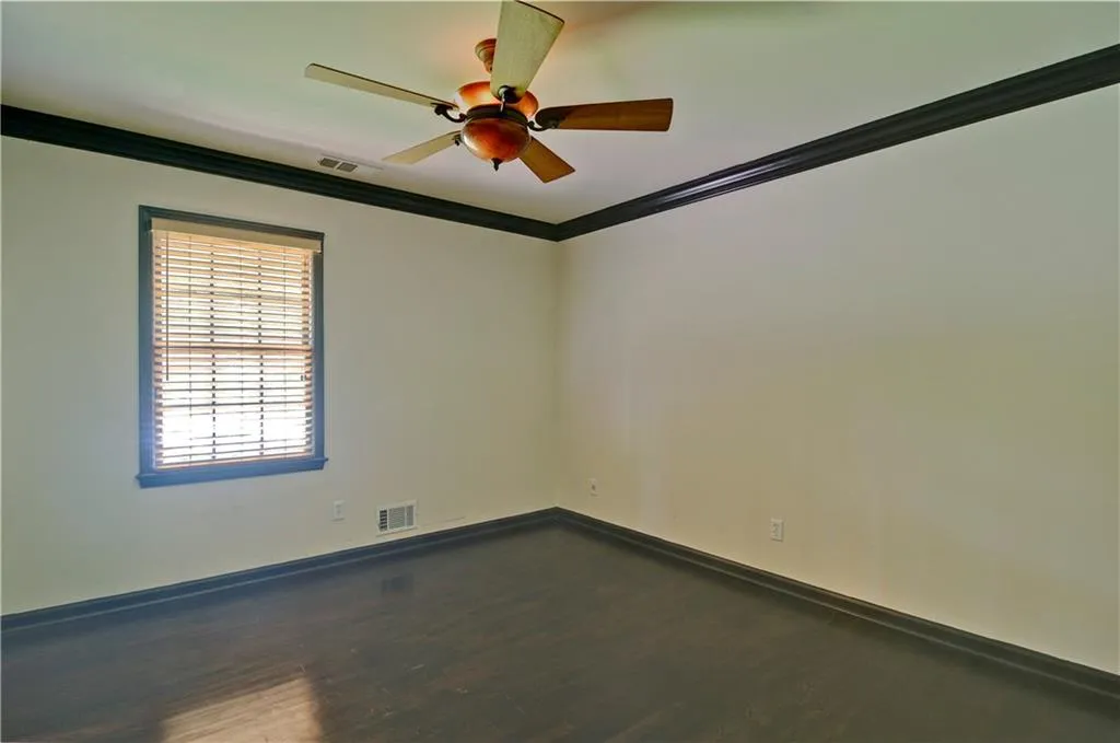 Bedroom #2 with crown molding, hardwood floors and a ceiling fan