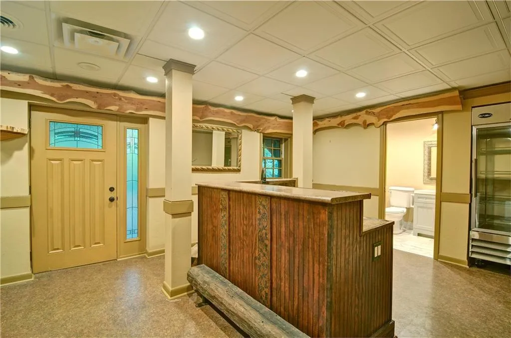 Large and fun bar located in the basement with cedar plank trim and separate outside entrance