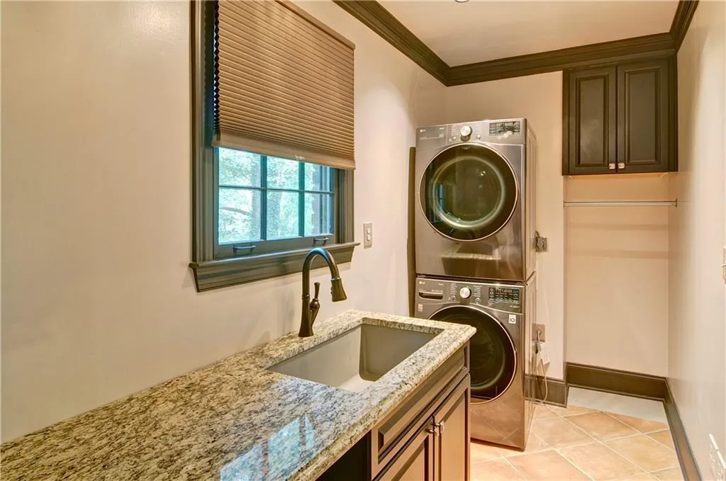 The stacked washer and dryer stay with home.  Lots of granite counter top for folding clothes and a convenient laundry room sink