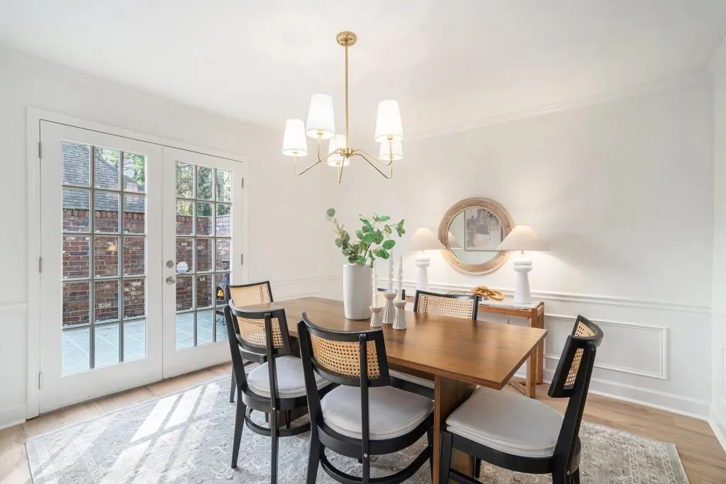 The Dining Room features Elegant Wainscoting Details and French Doors that open to your Private Patio the perfect spot for Morning Coffee, Grilling Out, or a cozy Wine Night.
