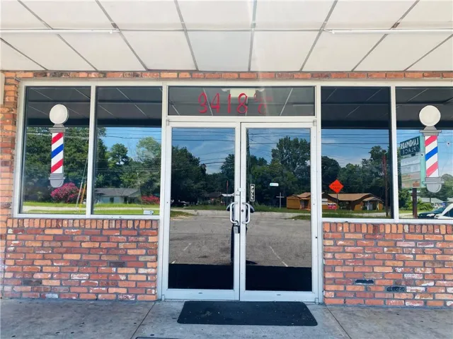 Commercial storefront featuring a brick facade and large display windows