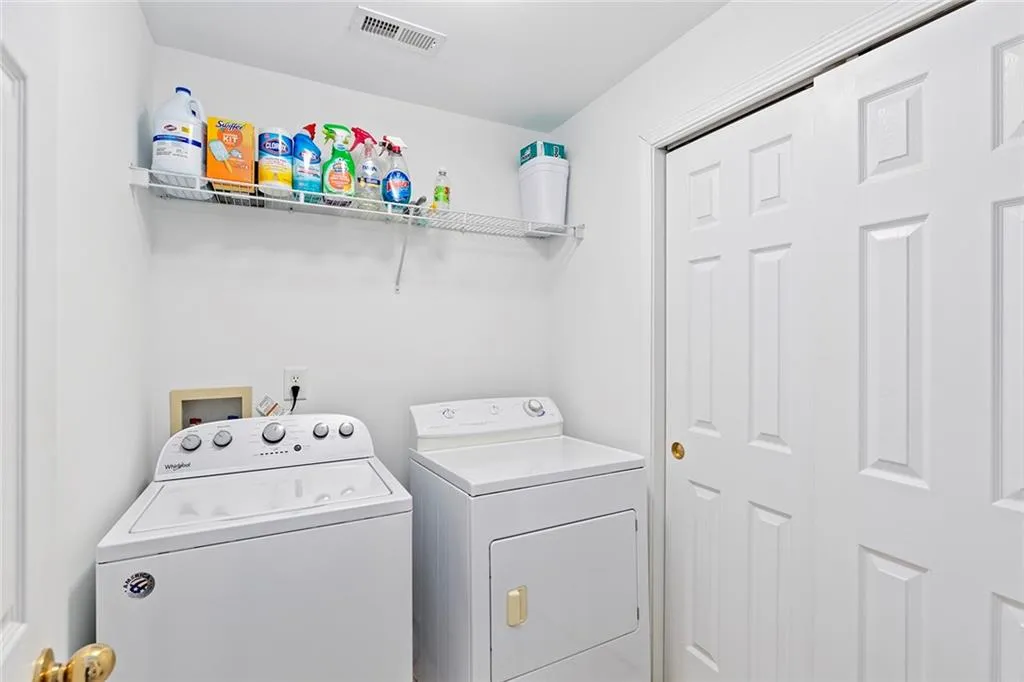 laundry room with extra storage in closet