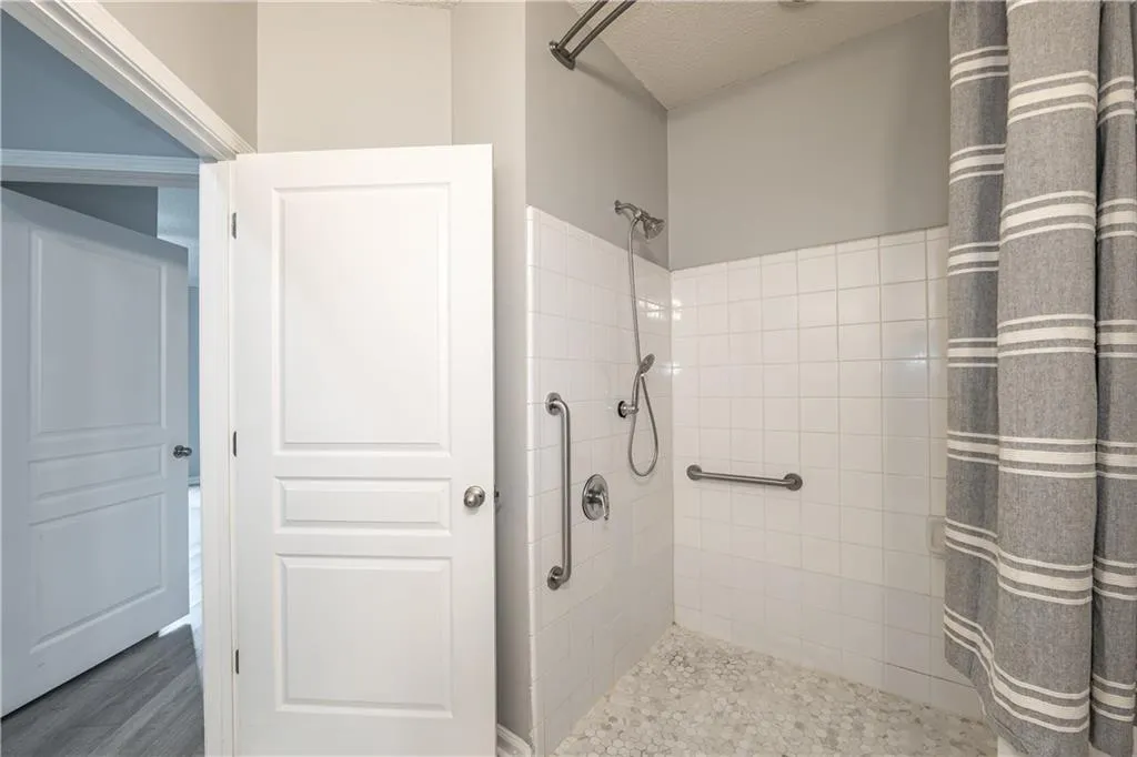 Full bath featuring tiled shower