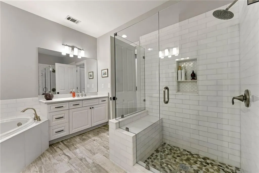 Bathroom with independent shower and bath, vanity, and hardwood / wood-style flooring