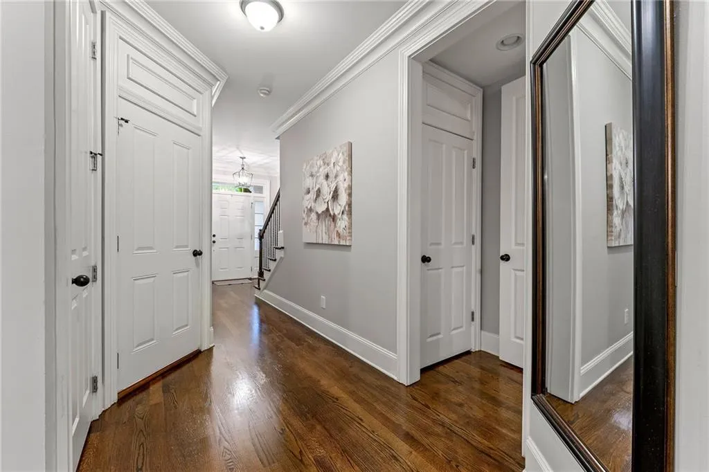 Hall with crown molding and dark hardwood / wood-style flooring