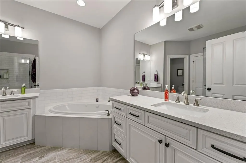 Bathroom featuring independent shower and bath, vanity, and hardwood / wood-style floors
