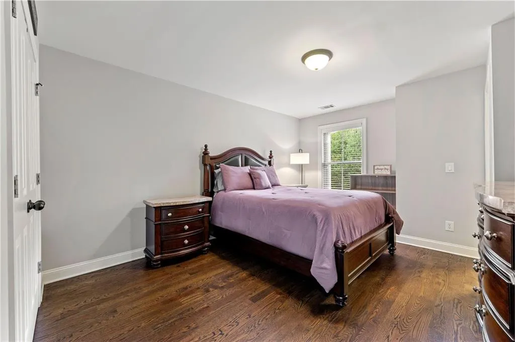 Bedroom with dark wood-type flooring