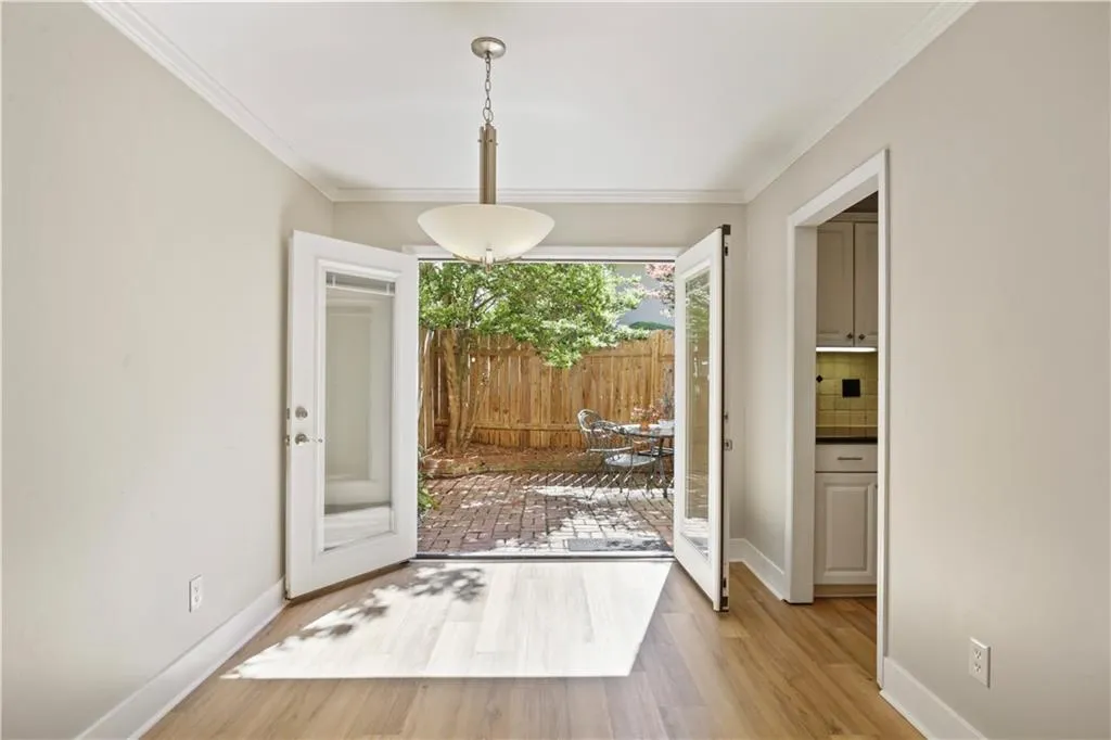 French doors leading to fenced brick patio