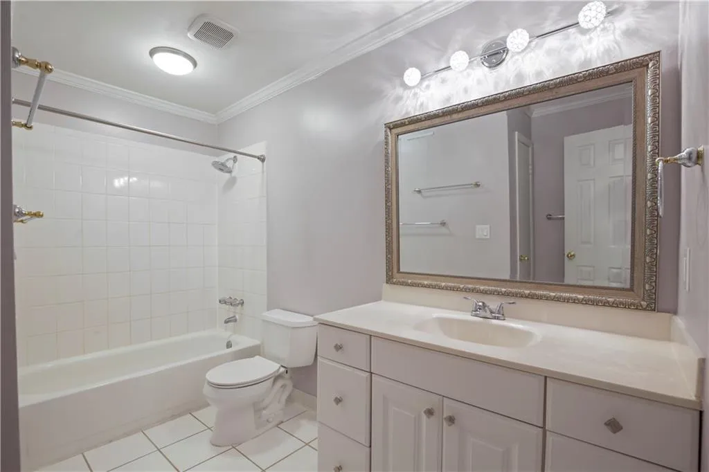 Full bathroom featuring vanity with extensive cabinet space, tiled shower / bath combo