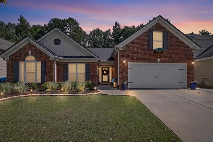 Brick exterior with white siding accents and dark shutters