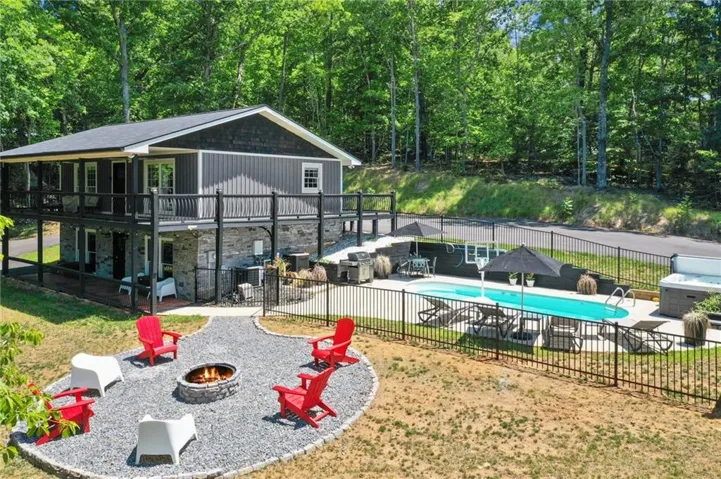 Two-story exterior with a stone foundation and vertical siding