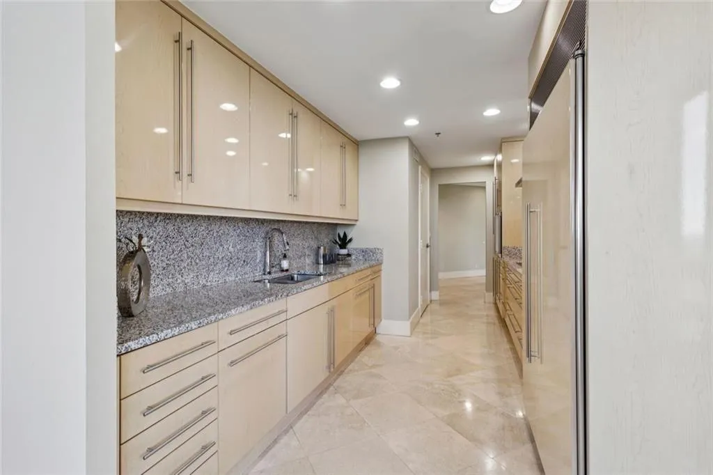 Soft close custom cabinetry with granite counters in the kitchen.