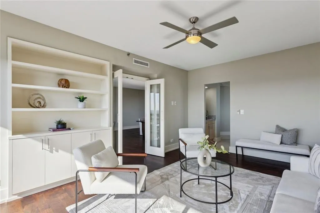 Den adjoins the Living room and the Kitchen .