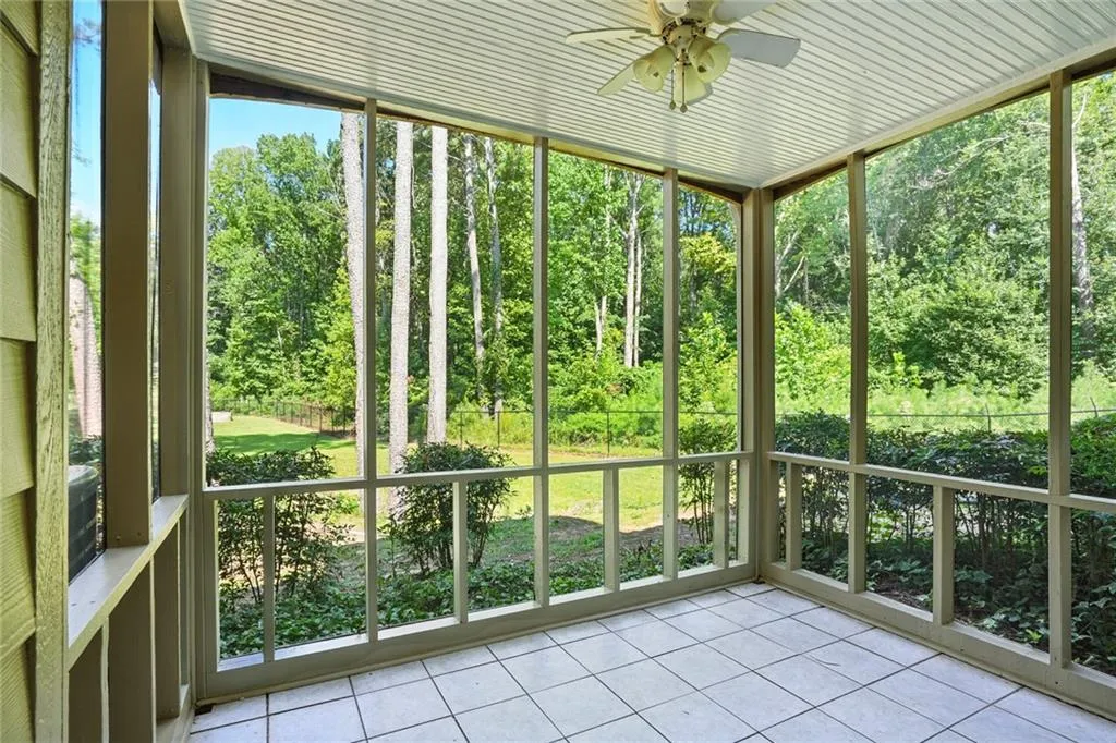 Unfurnished sunroom with ceiling fan