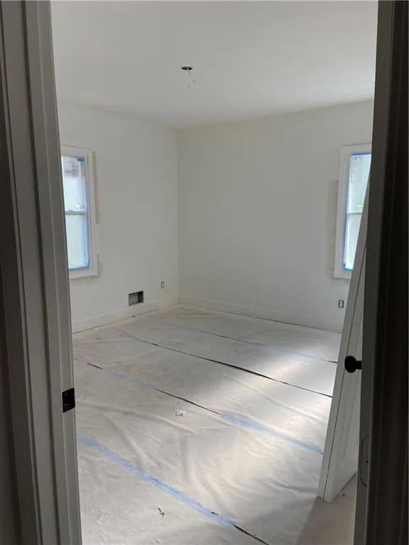 Empty room featuring plenty of natural light